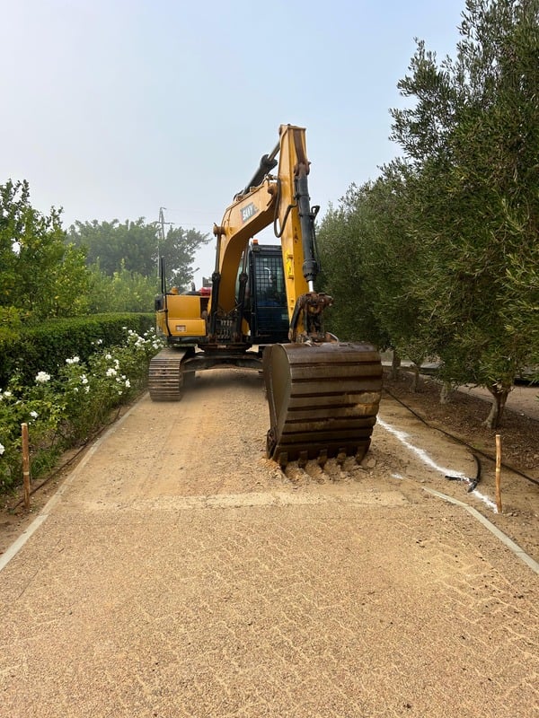 NR Civils excavator working on an exposed aggregate paved road